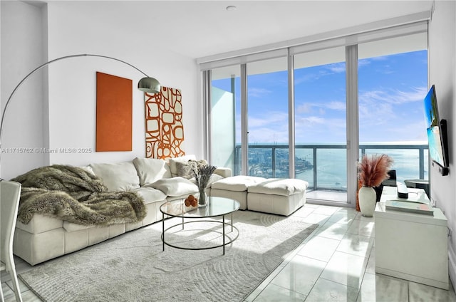 living room featuring light tile patterned floors and a wall of windows