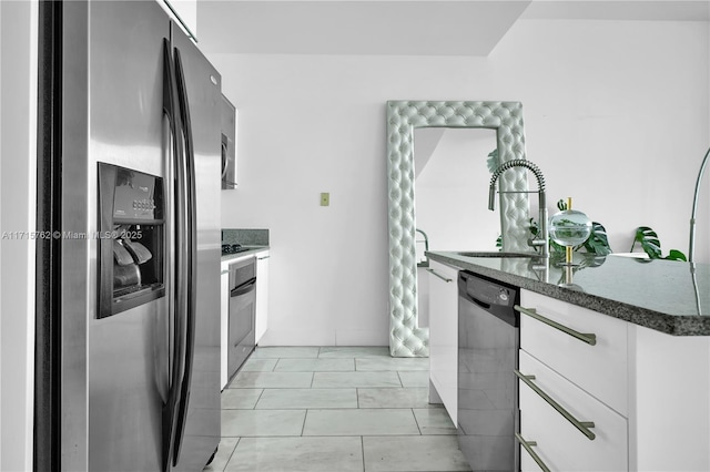 kitchen featuring light tile patterned flooring, sink, white cabinetry, and stainless steel appliances