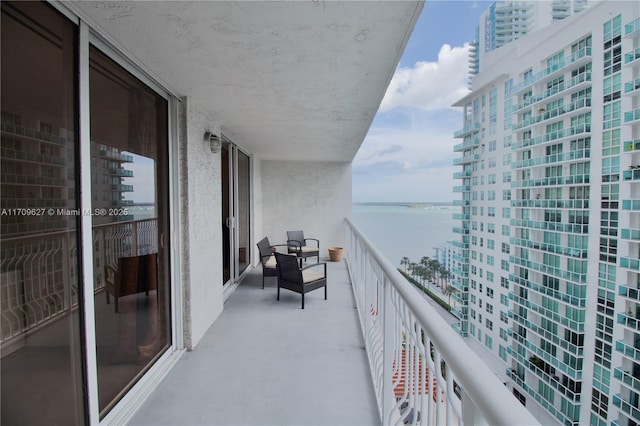 balcony featuring a water view