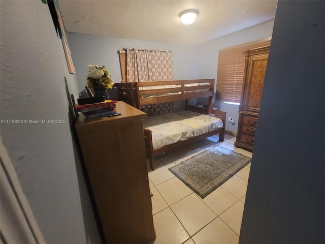 bedroom featuring light tile patterned floors