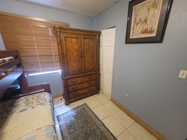 bedroom with light tile patterned floors