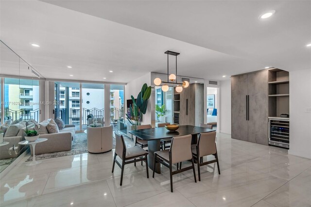 kitchen with a kitchen breakfast bar, sink, paneled refrigerator, light stone countertops, and an island with sink