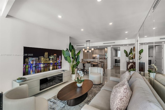 living area with visible vents, a chandelier, and recessed lighting