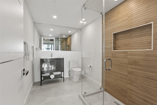 bathroom featuring vanity, toilet, and a shower with door