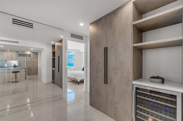 bar featuring beverage cooler, a dry bar, visible vents, and recessed lighting