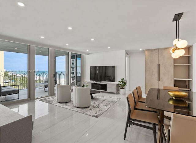 tiled living room featuring a wealth of natural light and a wall of windows