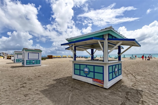 view of property's community with a view of the beach and a water view