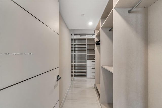 walk in closet featuring light tile patterned floors