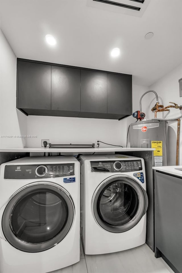 clothes washing area featuring recessed lighting, cabinet space, independent washer and dryer, and water heater