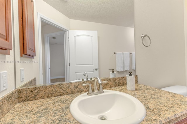 bathroom featuring vanity and a textured ceiling