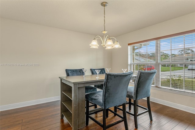 dining space featuring a notable chandelier, dark wood-type flooring, and a wealth of natural light