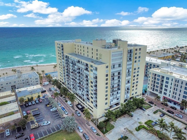 birds eye view of property with a beach view and a water view