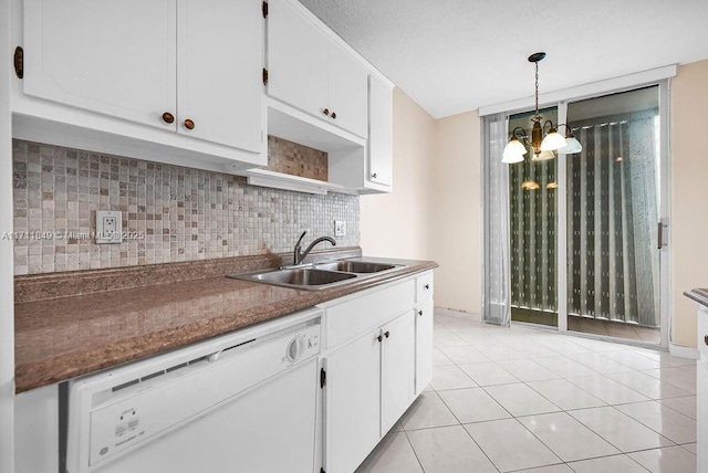 kitchen featuring dishwasher, white cabinets, sink, decorative backsplash, and a notable chandelier