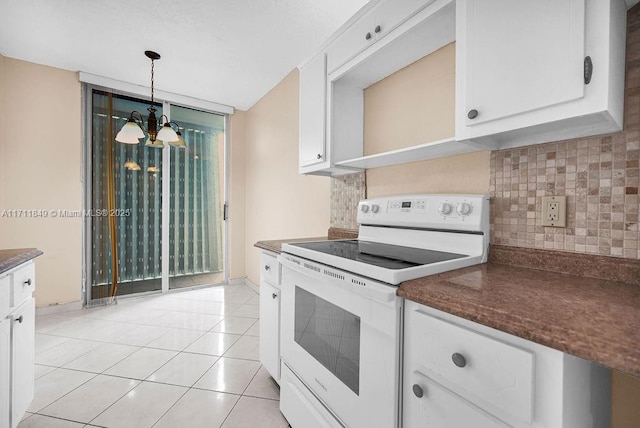 kitchen with an inviting chandelier, white cabinets, white electric stove, hanging light fixtures, and light tile patterned floors