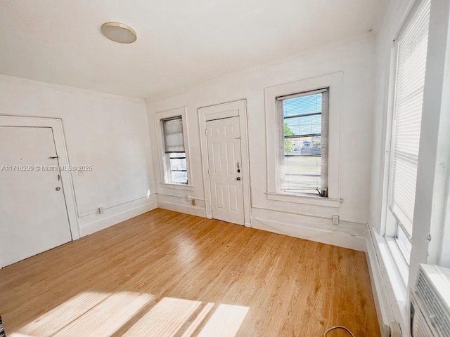 entryway with heating unit and wood-type flooring