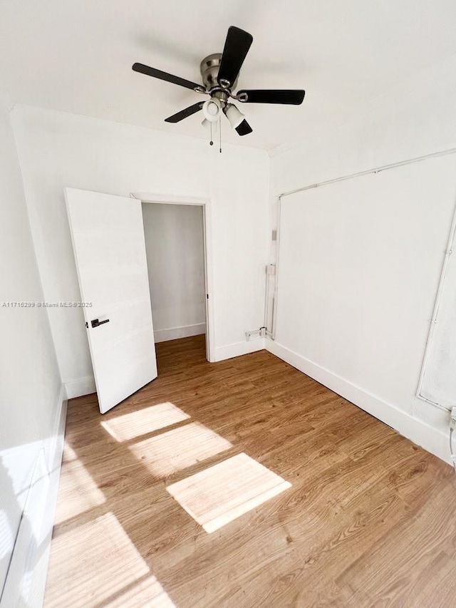 unfurnished bedroom with a closet, ceiling fan, and hardwood / wood-style floors