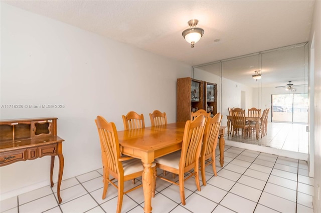 tiled dining area featuring ceiling fan