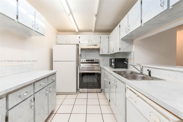 kitchen with white cabinets, white appliances, sink, and light tile patterned floors