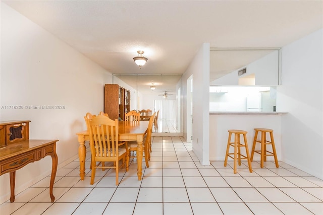 dining area featuring light tile patterned flooring