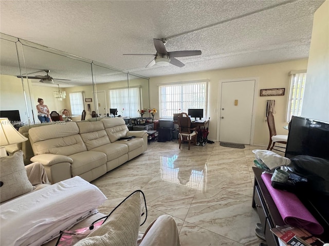 living room featuring a textured ceiling and ceiling fan