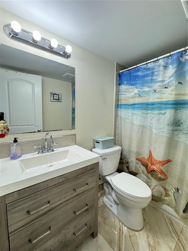 bathroom with vanity, a shower with shower curtain, and toilet