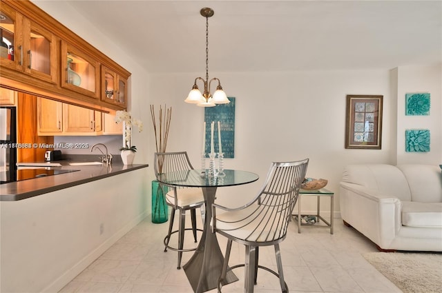 dining space featuring sink and an inviting chandelier