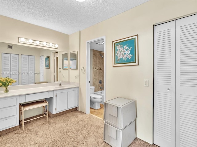 full bathroom featuring a textured ceiling, vanity, toilet, and  shower combination