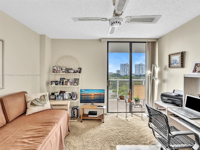 carpeted living room with ceiling fan, built in features, and a textured ceiling