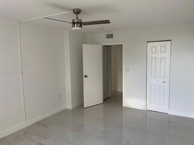 unfurnished bedroom featuring ceiling fan