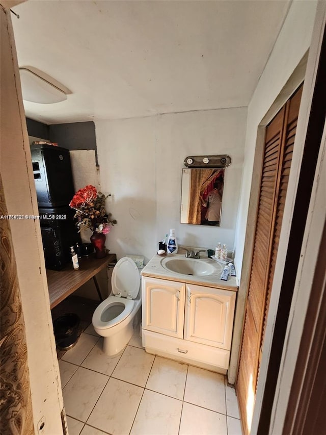 bathroom featuring tile patterned floors, vanity, and toilet