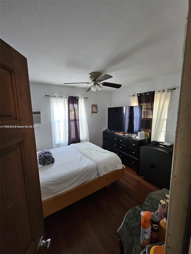 bedroom with ceiling fan and dark hardwood / wood-style flooring