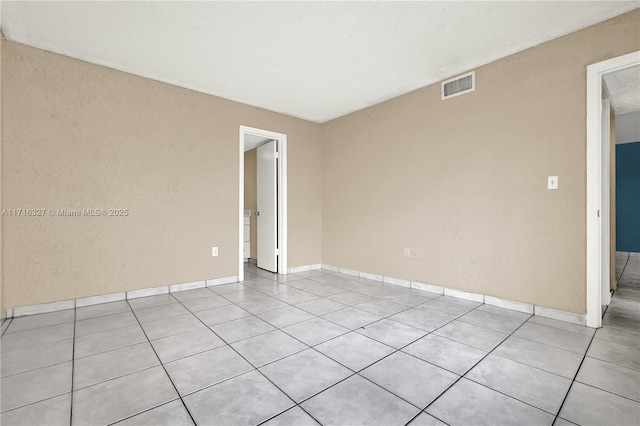 spare room featuring light tile patterned floors