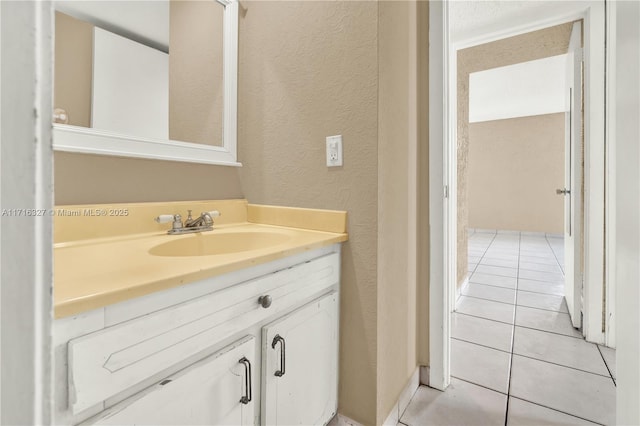 bathroom featuring tile patterned flooring and vanity