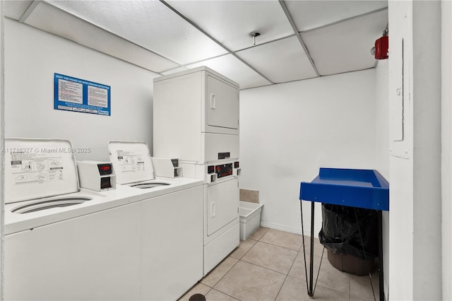 washroom with washing machine and dryer, light tile patterned floors, and stacked washer and dryer