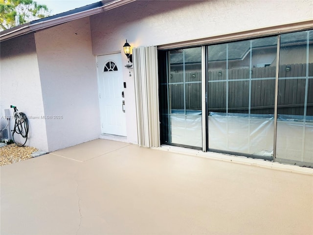 151 NW 115th Ave Unit 405, Plantation, FL 33325 - view of exterior entry featuring stucco siding and a patio area