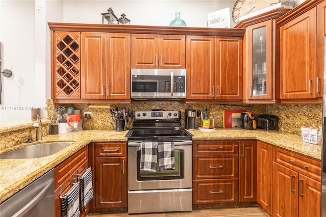 151 NW 115th Ave Unit 405, Plantation, FL 33325 - kitchen featuring appliances with stainless steel finishes, glass insert cabinets, and light stone counters