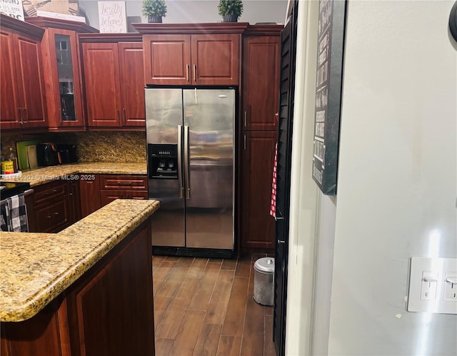 kitchen with stainless steel fridge, dark hardwood / wood-style flooring, and backsplash