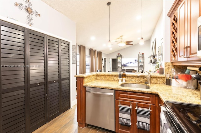 kitchen with stainless steel dishwasher, pendant lighting, light stone counters, and sink