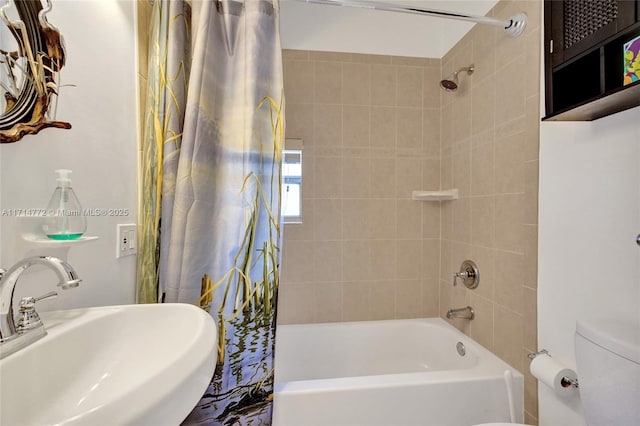 full bathroom featuring shower / bath combo with shower curtain, a sink, and toilet