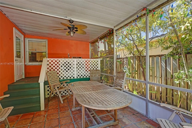 sunroom / solarium featuring a ceiling fan and wood ceiling