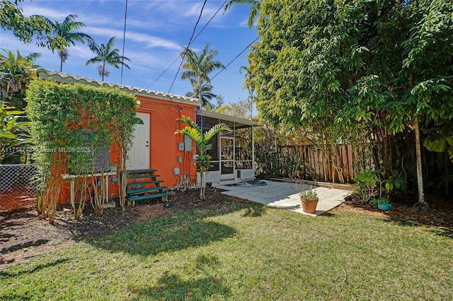 view of yard with entry steps, fence, and a patio