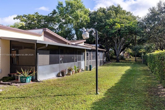 view of yard with a sunroom