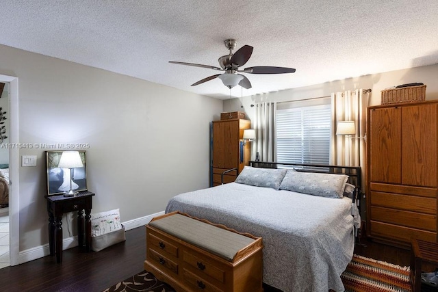 bedroom with a textured ceiling, dark hardwood / wood-style floors, and ceiling fan