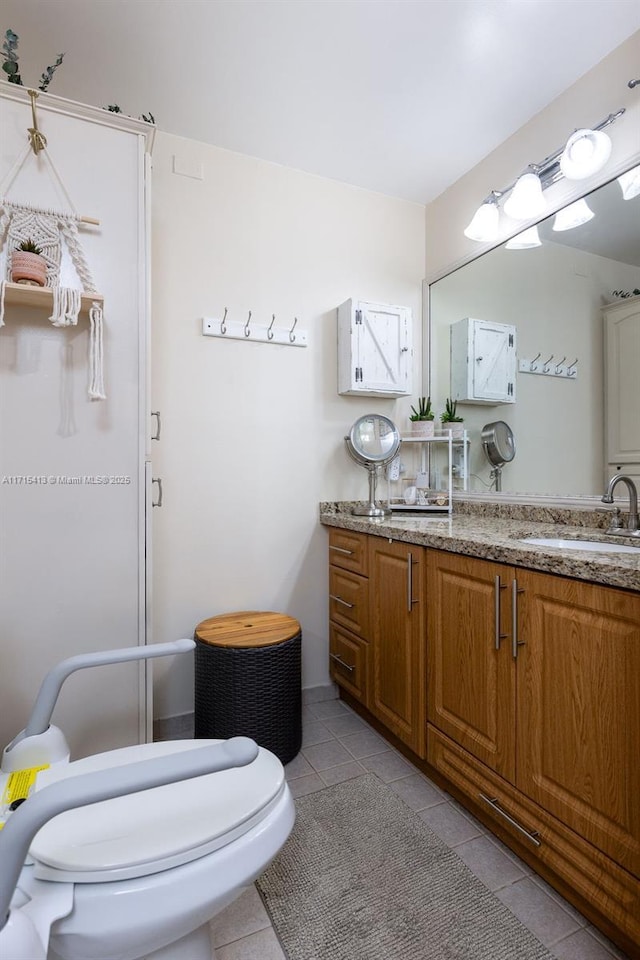 bathroom featuring tile patterned floors, vanity, and toilet