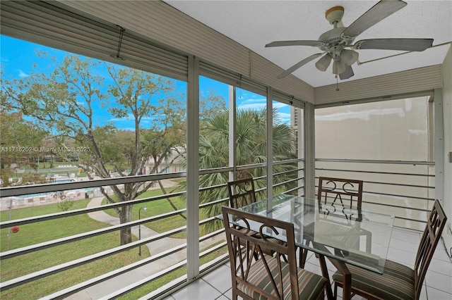 sunroom / solarium featuring ceiling fan