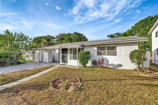 ranch-style house with a carport and a front lawn