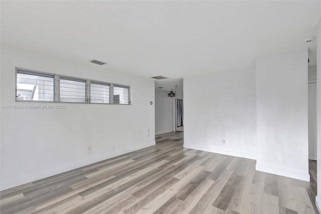 spare room featuring light hardwood / wood-style flooring