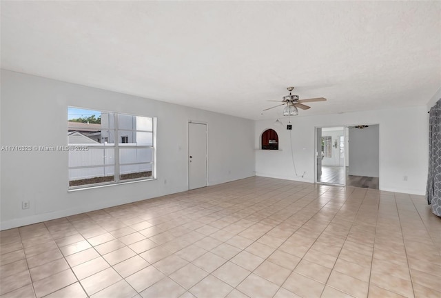 empty room featuring ceiling fan and light tile patterned floors