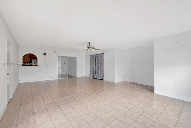 spare room with ceiling fan and light tile patterned floors