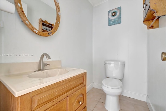 bathroom with tile patterned flooring, vanity, and toilet